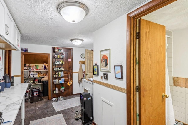 hallway featuring a textured ceiling