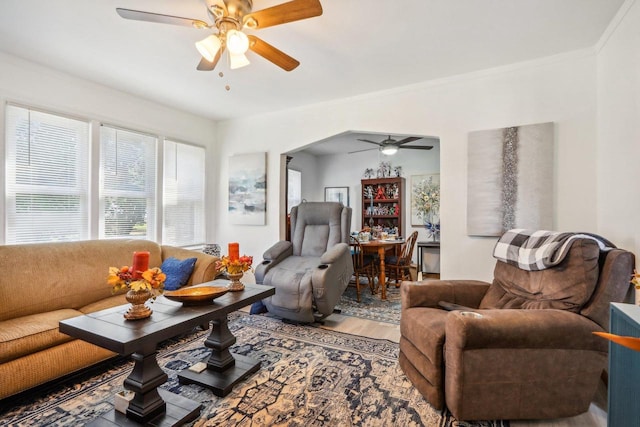 living room with ceiling fan, crown molding, and hardwood / wood-style floors