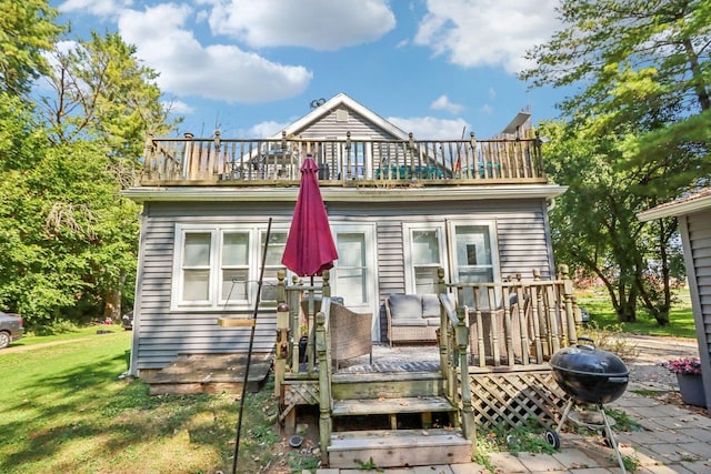 exterior space with a wooden deck and a front lawn