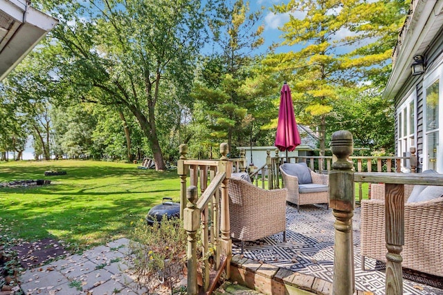 deck featuring a patio and a yard