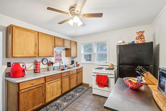 kitchen featuring sink, black appliances, light tile patterned floors, ornamental molding, and ceiling fan