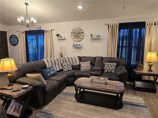 living room with a notable chandelier and hardwood / wood-style flooring