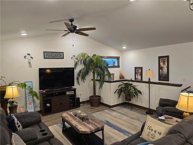 living room with wood-type flooring, vaulted ceiling, and ceiling fan