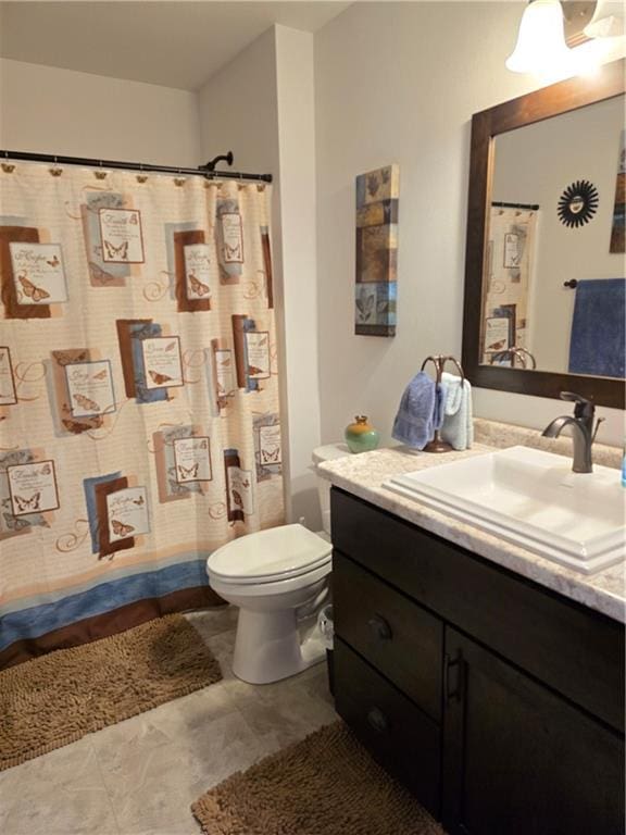 bathroom with walk in shower, vanity, and toilet