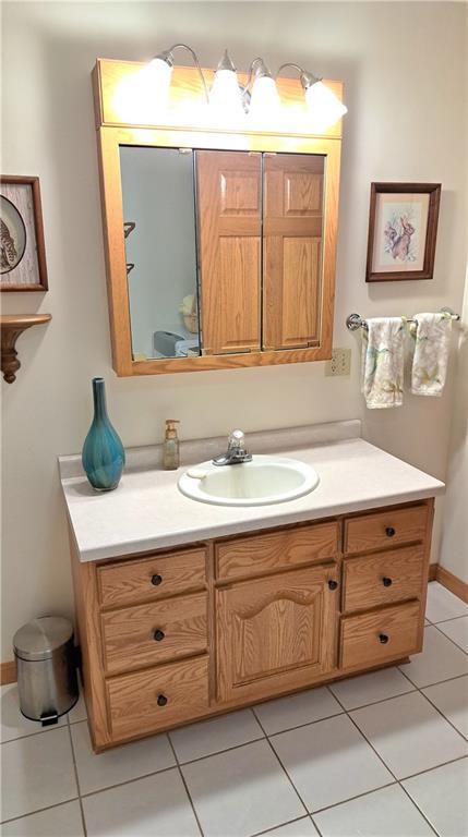 bathroom with tile patterned floors and vanity