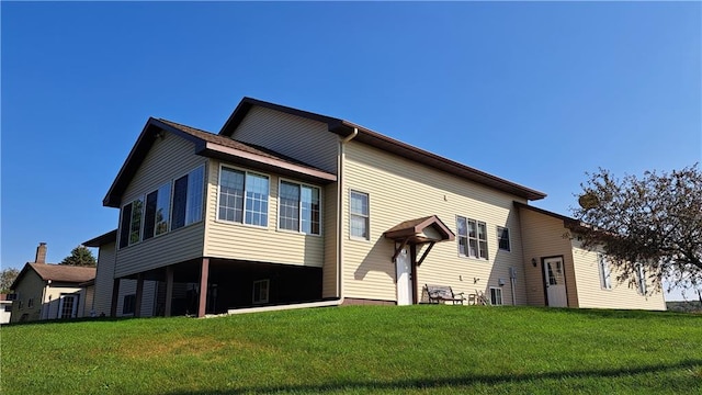 rear view of property with a lawn