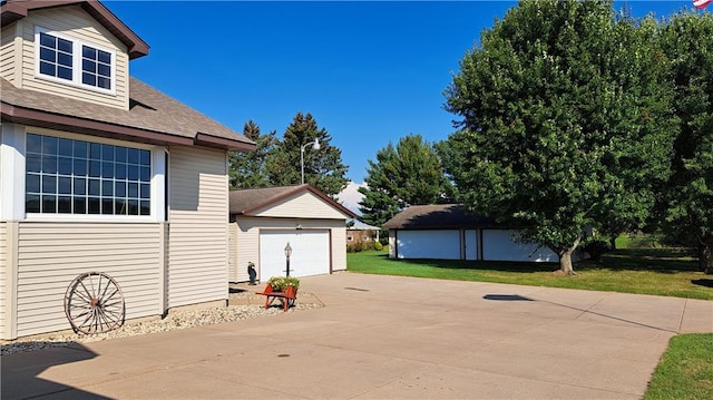 view of patio featuring an outbuilding and a garage