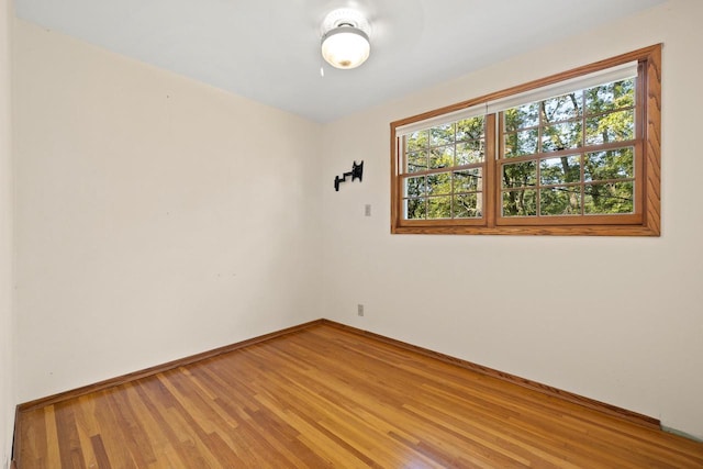 spare room with hardwood / wood-style flooring