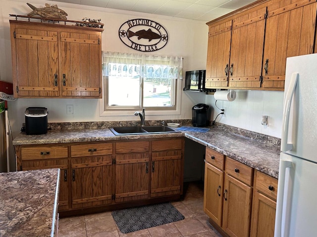 kitchen with sink, white fridge, and tile patterned floors