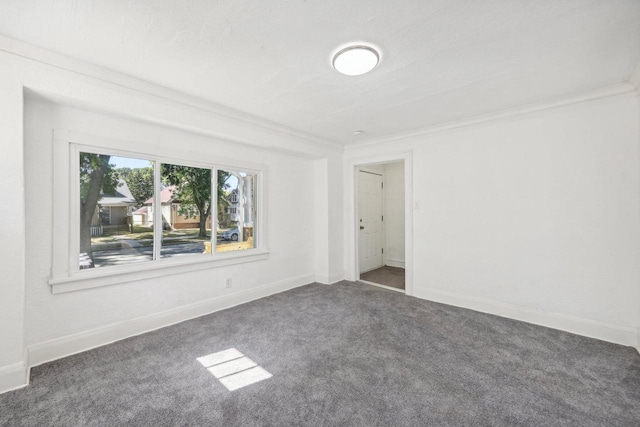 carpeted spare room with crown molding