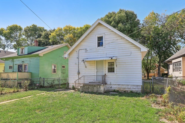 rear view of property with a lawn