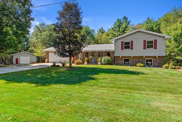 split level home featuring a garage, an outdoor structure, a porch, and a front yard