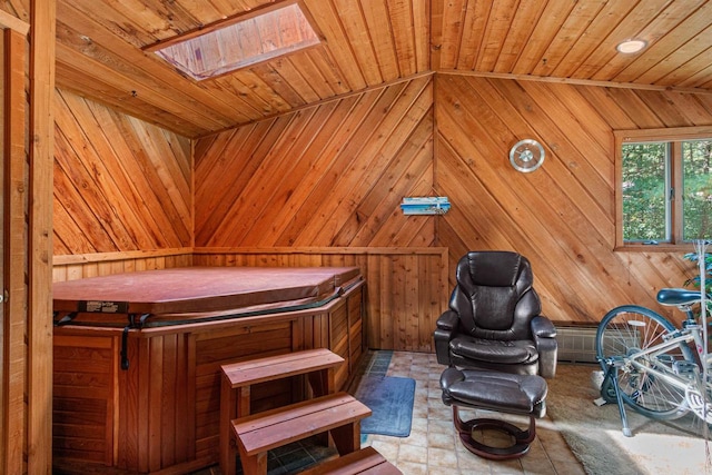 miscellaneous room featuring a skylight and wood walls