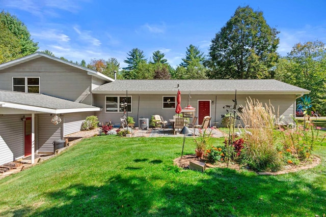 back of house featuring cooling unit, a yard, and a patio area