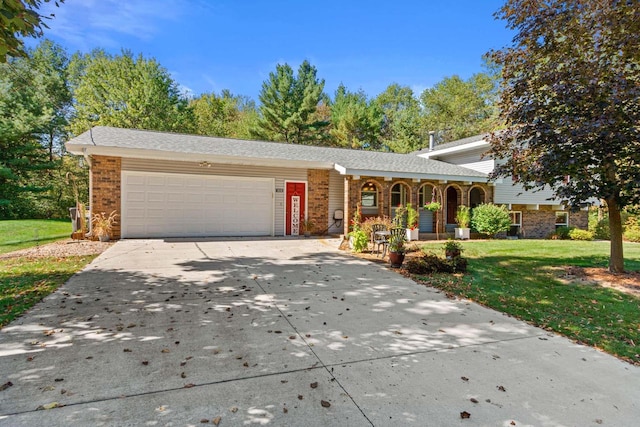 tri-level home with a garage, a front yard, and a porch