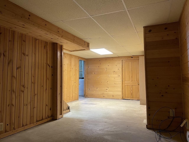 basement featuring wooden walls