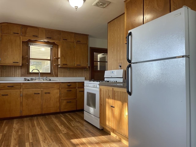 kitchen featuring white appliances, sink, and dark hardwood / wood-style flooring