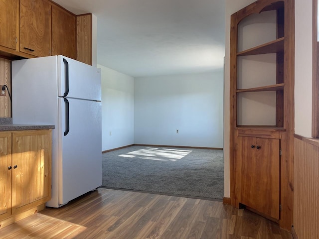 kitchen featuring hardwood / wood-style flooring and white fridge