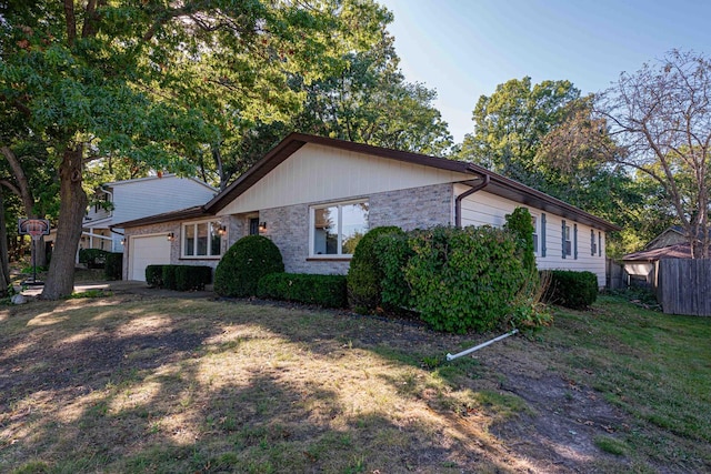 ranch-style home featuring a front lawn and a garage