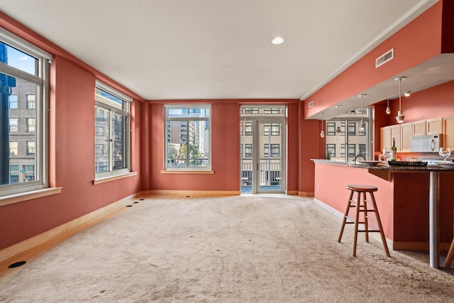 carpeted living room with crown molding