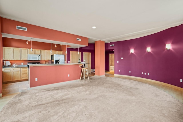 unfurnished living room featuring light colored carpet