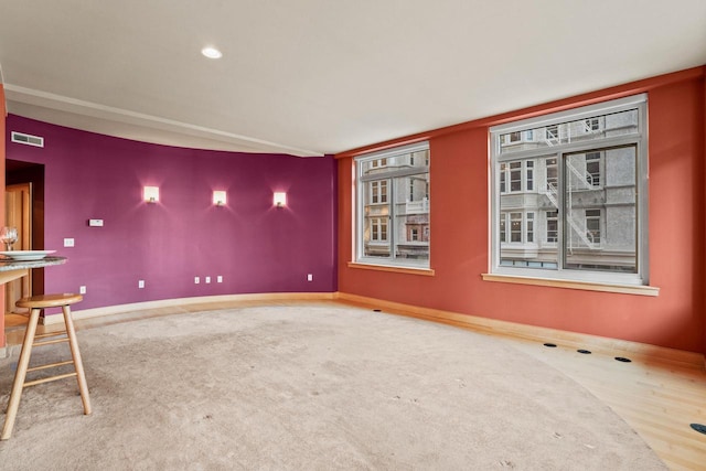 unfurnished room with wood-type flooring and bar