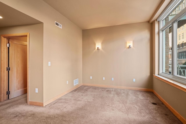 unfurnished room with light carpet