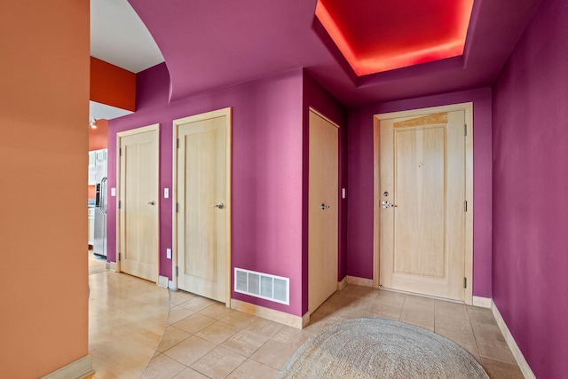 hall with light tile patterned floors