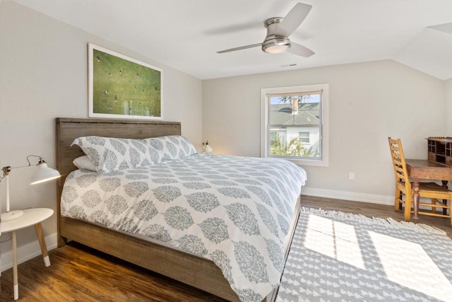 bedroom featuring vaulted ceiling, dark hardwood / wood-style floors, and ceiling fan