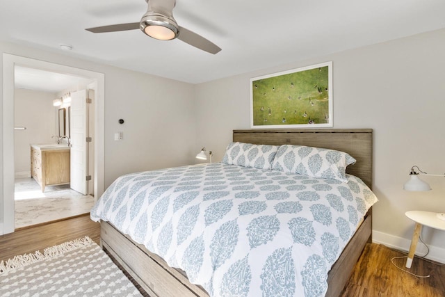 bedroom with ceiling fan, sink, connected bathroom, and hardwood / wood-style floors