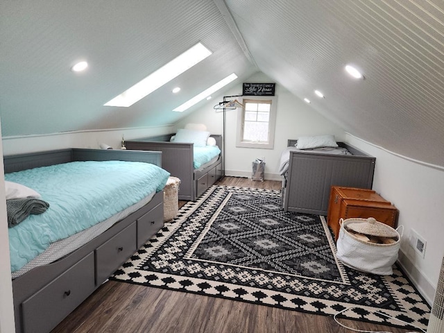 bedroom featuring vaulted ceiling with skylight and dark hardwood / wood-style flooring