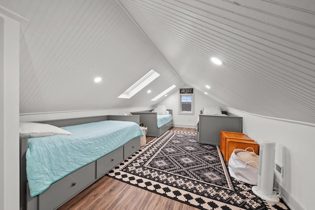 bedroom featuring vaulted ceiling with skylight and dark wood-type flooring