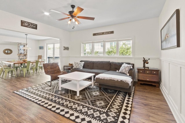 living room with hardwood / wood-style floors and ceiling fan