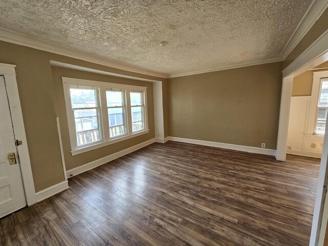 empty room featuring a textured ceiling, ornamental molding, and dark wood-type flooring