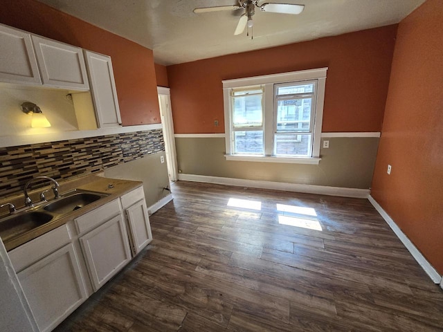 kitchen with ceiling fan, sink, dark hardwood / wood-style flooring, and white cabinetry