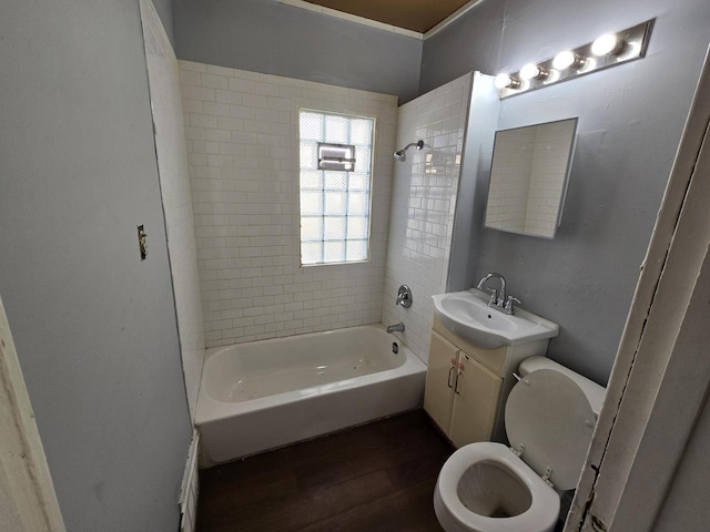 full bathroom with vanity, hardwood / wood-style flooring, tiled shower / bath, and toilet