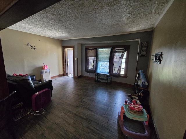 living room featuring a textured ceiling, ornamental molding, and dark hardwood / wood-style floors