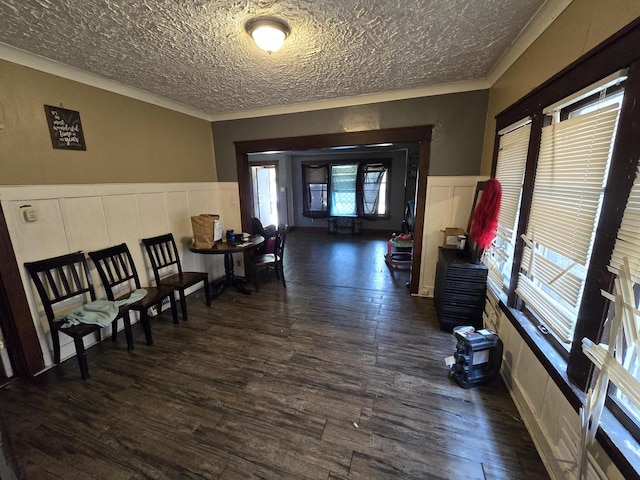 interior space featuring a textured ceiling, crown molding, and dark hardwood / wood-style flooring