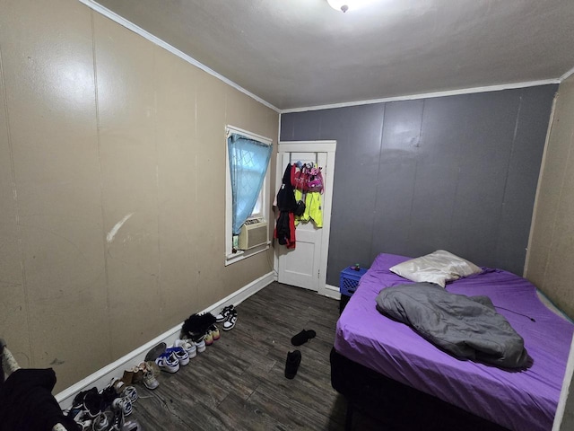 bedroom featuring ornamental molding, cooling unit, a closet, and dark hardwood / wood-style flooring