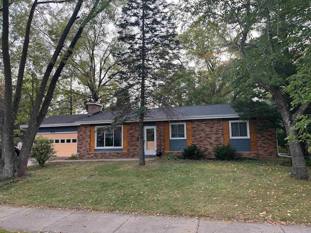 view of front facade with a front yard and a garage