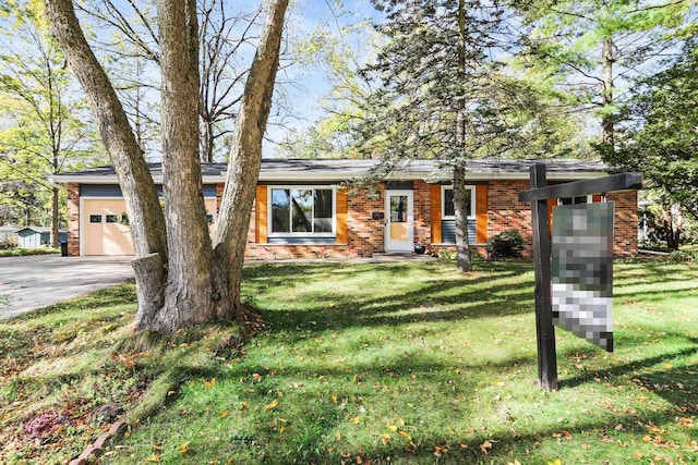 view of front of property with a front yard and a garage