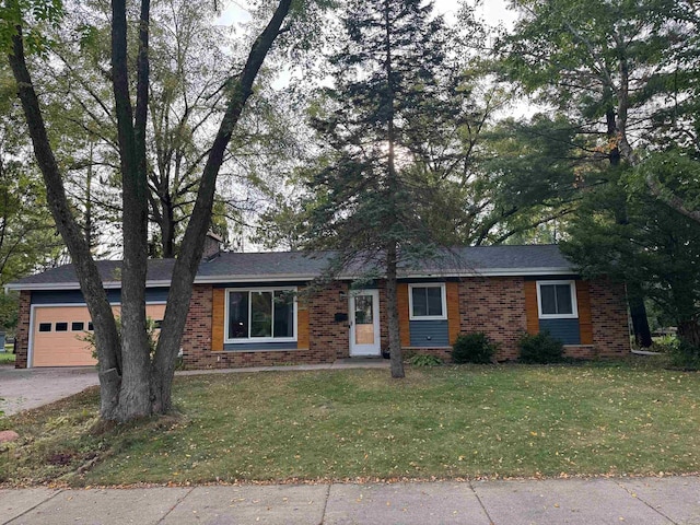 single story home featuring a garage and a front lawn