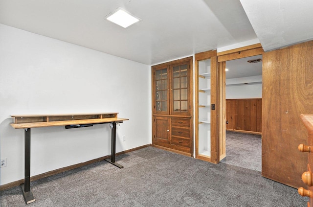 interior space featuring wood walls and carpet