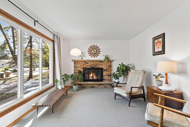 living area with a fireplace and carpet flooring