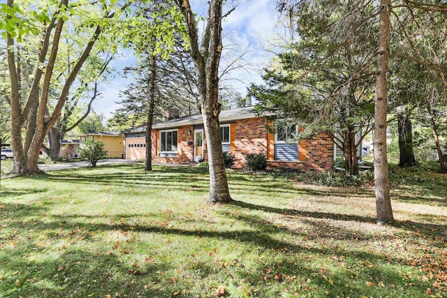 single story home with a front yard and a garage