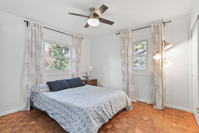 bedroom featuring parquet flooring and ceiling fan