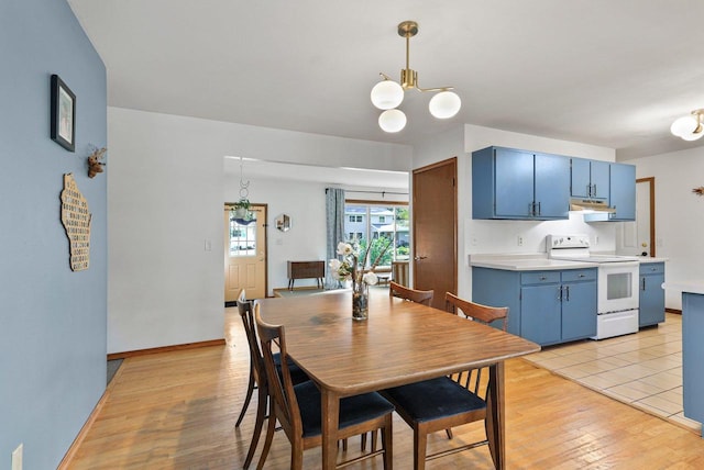 dining area featuring a notable chandelier and light hardwood / wood-style floors