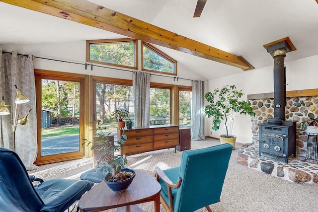 interior space with a wood stove and lofted ceiling with beams