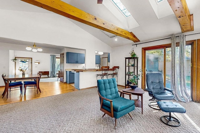 sitting room with high vaulted ceiling, an inviting chandelier, light hardwood / wood-style flooring, a skylight, and beam ceiling