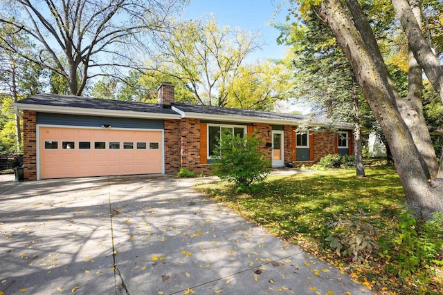 view of front of property featuring a garage and a front lawn